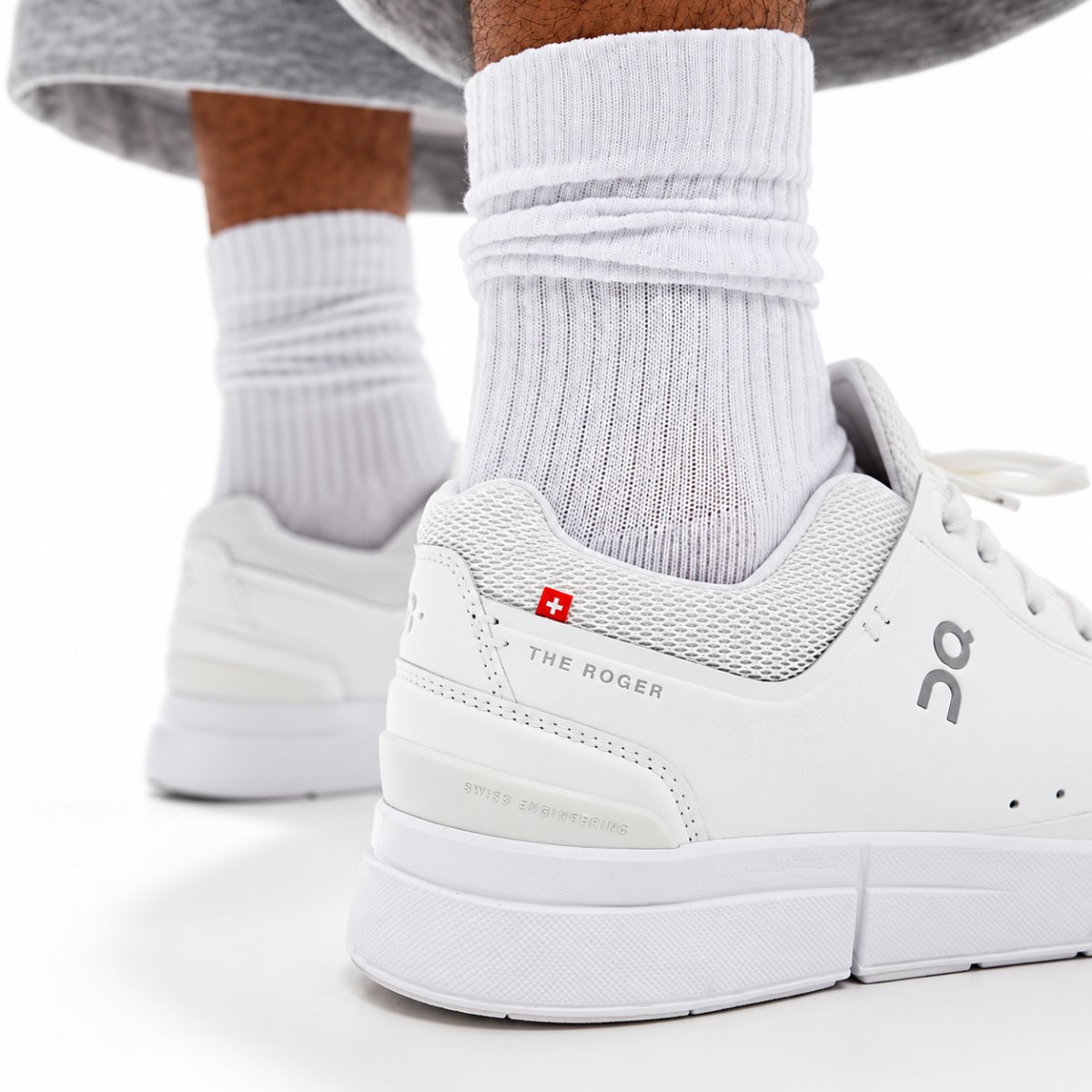 On The Roger Advantage all white heel close-up with THE ROGER and the red Swiss cross