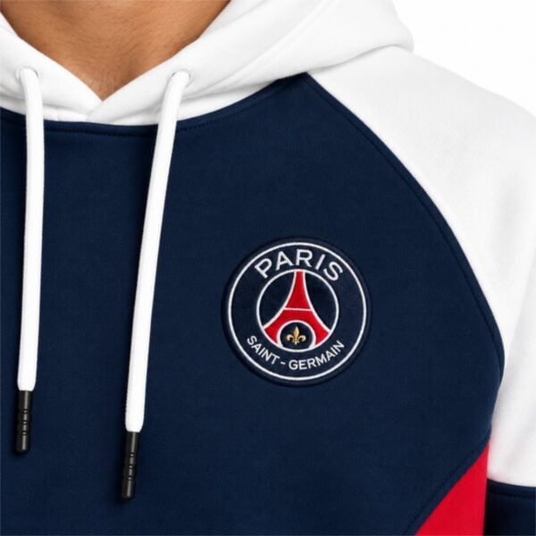 PSG hoodie close-up of embroidered Paris Saint-Germain crest with Eiffel Tower and gold fleur-de-lis