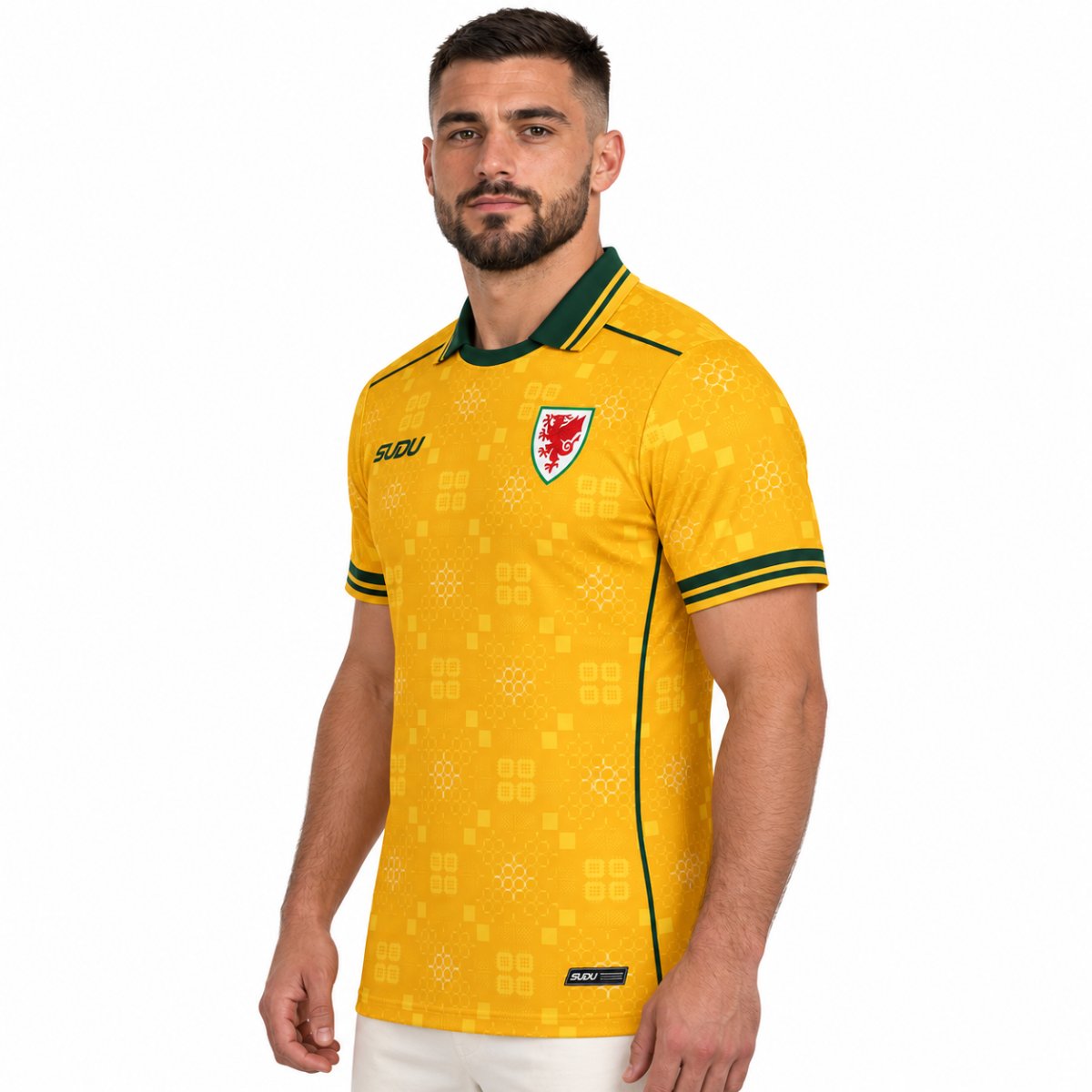 Wales away jersey 2026 2027 angled view yellow with tonal Welsh quilt pattern - UAE SPORT STORE Angled view of the yellow Wales shirt with green trim, a red dragon crest and geometric patterns.