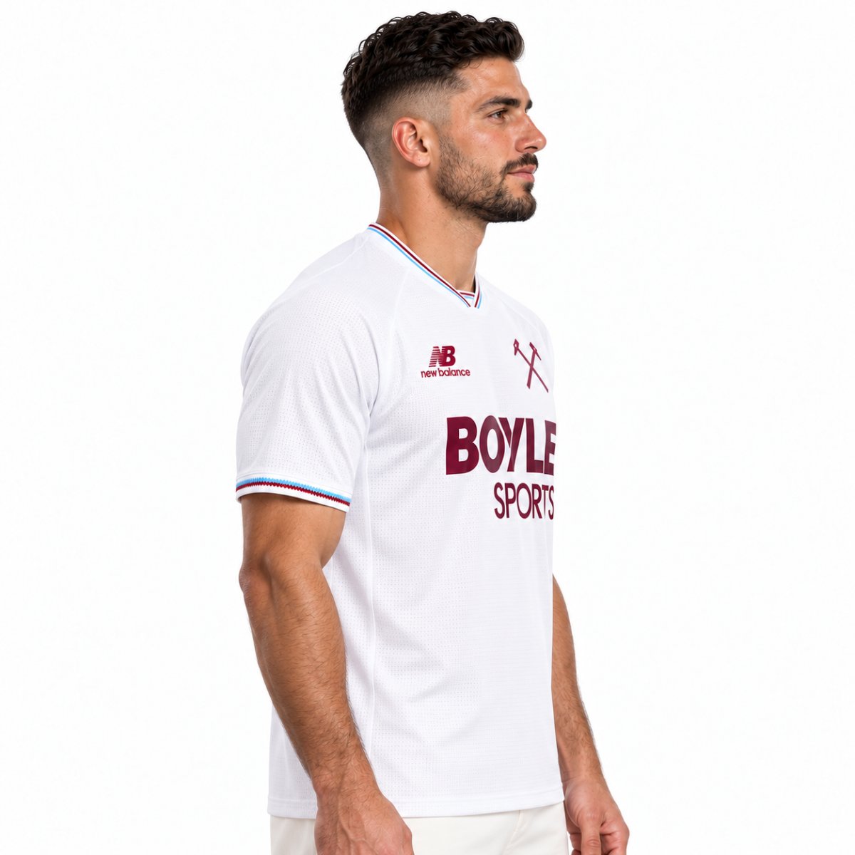 West Ham United away jersey side view showing raglan sleeve and zig-zag cuff trim - UAE SPORT STORE Side view of the white West Ham United shirt with claret BOYLE SPORTS lettering and collar trim.